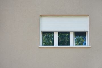 Light roller shutter curtains on a white window