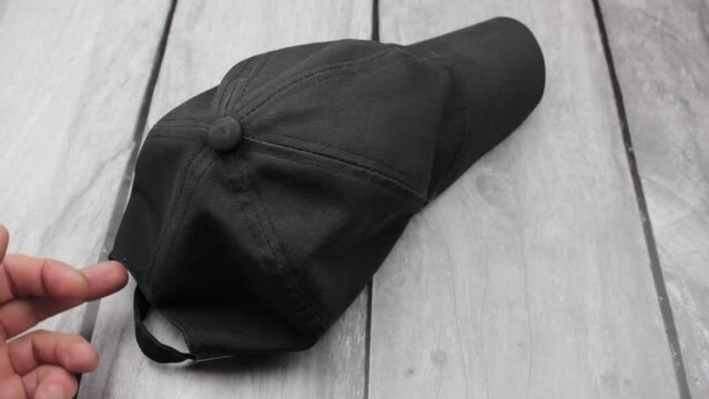 Black men's baseball cap. The fabric cap is black.
