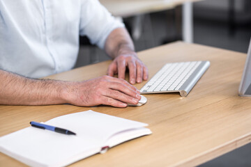 Close-up photo of man's hands in the office working with a computer keyboard