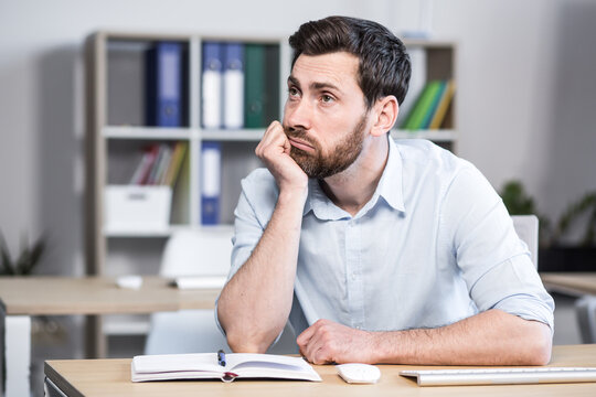 Close-up portrait of pensive man in office, businessman thinking over decision