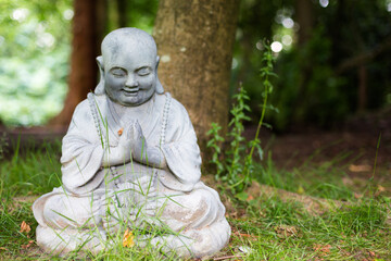 Figure of peaceful Buddha meditating under a tree. Meditation. Mental health awareness.