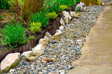 Garden bed edging. Garden path border design. Garden area separating
