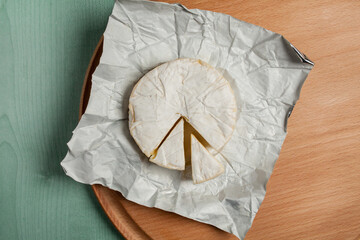 cheese brie camembert, on a wooden light background. view from above. Camembert cheese. Cheese brie...