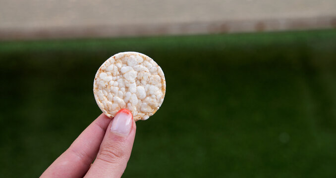 Fingers Holding A Mini Puffed Rice Pancake