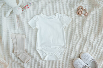 White baby short sleeve bodysuit in scandinavian interior with minimalistic decoration, mockup.