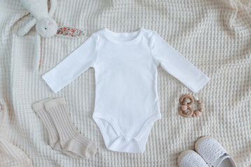 White baby long sleeve bodysuit in scandinavian interior with minimalistic decoration, mockup.