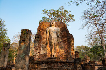 Fototapeta premium Ancient Standing Buddha Statue in historical park