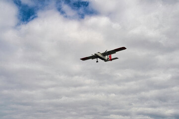 Fototapeta na wymiar landing small plane over the sea