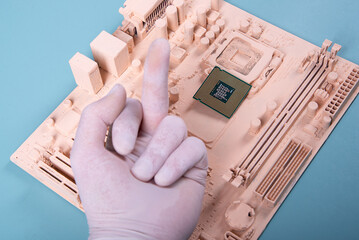 motherboard and a hand holding a microprocessor on a blue background in paint