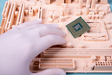 motherboard and a hand holding a microprocessor on a blue background in paint