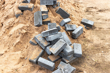 Dismantled paving slabs. Reconstruction of the sidewalk in the city. Construction work on the improvement of the territory. Close-up. Background.