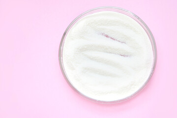 Collagen white powder. Pastel color background. Health product. Woman cosmetics concept. Sport...