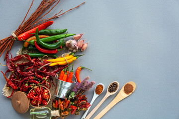 different seasonings for cooking, varieties of hot chilli pepper, ground pepper and spices, oil....