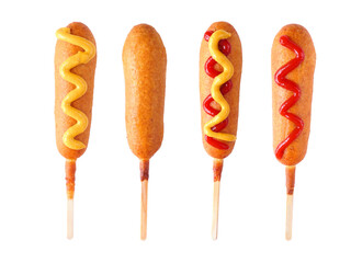 Four corn dogs with different toppings isolated on a white background - 504629030