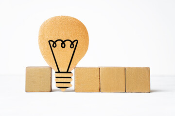 Blank letter blocks and a flat light bulb shape