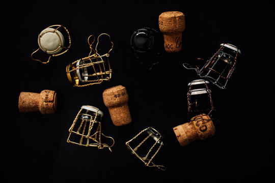 assorted champagne cages and corks on black background