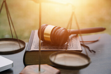Justice and law concept.Male judge in a courtroom with the gavel, working with, computer and...