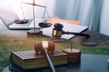 Justice and law concept.Male judge in a courtroom with the gavel, working with, computer and...