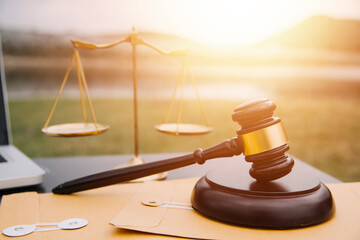 Justice and law concept.Male judge in a courtroom with the gavel, working with, computer and...