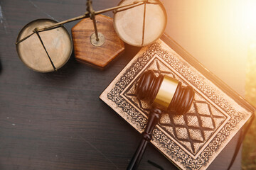 Justice and law concept.Male judge in a courtroom with the gavel, working with, computer and docking keyboard, eyeglasses, on table in morning light