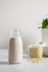 Vegan cereal green buckwheat milk in glass. Close up. Dairy free plant based milk replacer. Vertical.