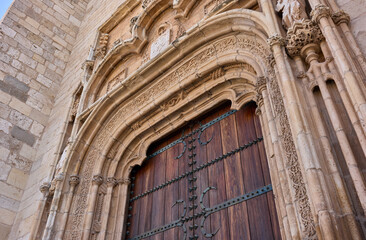 Principal gate detail on the western facade of the Magistral Cathedral of Saints Justo and Pastor. Alcala de Henares, Region of Madrid, Spain.