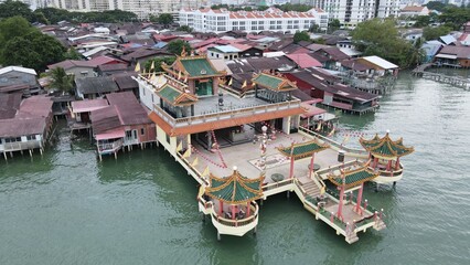Fototapeta na wymiar Georgetown, Penang Malaysia - May 13, 2022: The Clan Jetties of Georgetown Penang, Malaysia. Wooden villages built on stilts at the sea coast by the different clans of the Penang Chinese community.