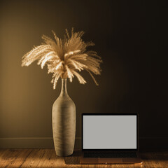 Laptop computer with blank screen, pampas grass bouquet in sunlight shadows on the wall. Aesthetic influencer boho styled interior design template with mockup copy space