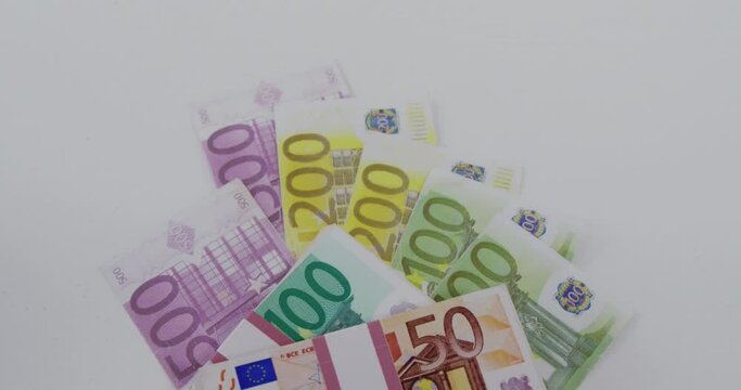 Animation of tax day text over euro banknotes on white background