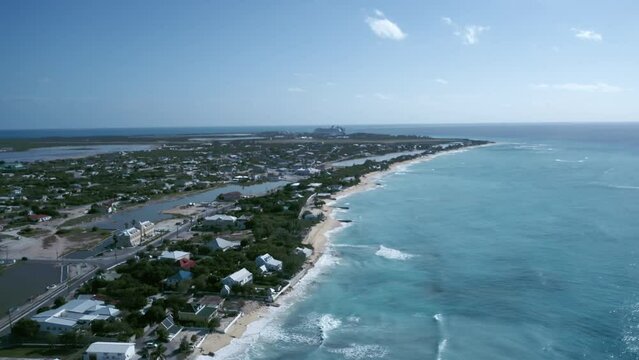 Drone camera flies toward coastal area of Cockburn Town, Grand Turk, Turks and Caicos, aerial footage from tropical island
