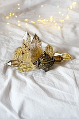 Crystal minerals and vintage aroma incense burner on fabric background. gemstones for spiritual...