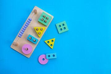 Colorful wooden domino toys for children on blue background.