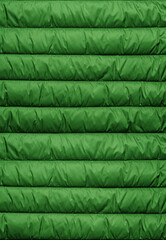 Quilted pattern. Texture of puffer, padded, down jacket. Background of urban winter outfit.