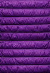 Quilted pattern. Texture of puffer, padded, down jacket. Background of urban winter outfit.
