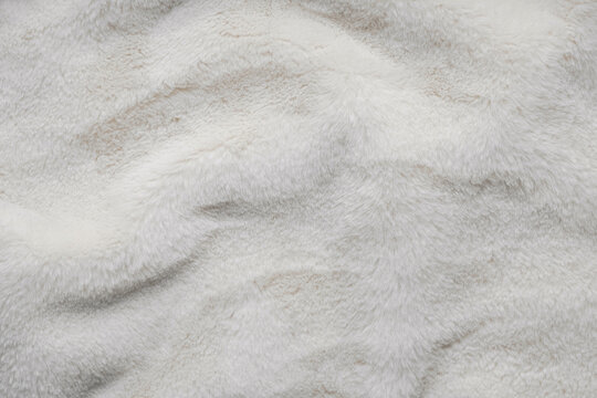 Texture of faux fur. Empty place for text, quote or sayings. Top view. Closeup. Light fur back.