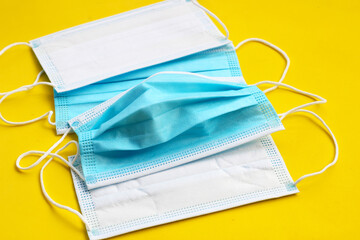 Medical protective masks on yellow background.