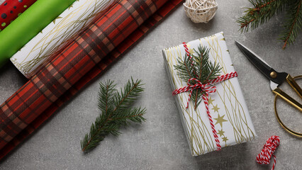 Flat lay composition with beautifully wrapped gift box on grey stone table