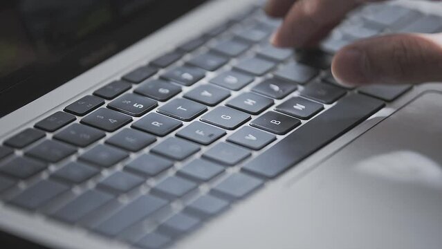 Close up of a young man hand busy typing. 
