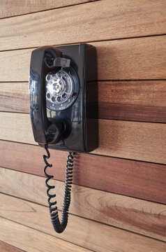Old telephones hanging on the wall.
