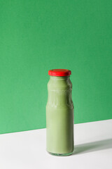 green smoothie on green and white background, copy space. vegan food concept. Healthy, diet, detox food. quick snack for office. Healthy breakfast