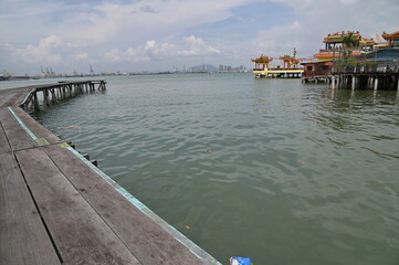 Georgetown, Penang Malaysia - May 13, 2022: The Clan Jetties of Georgetown Penang, Malaysia. Wooden villages built on stilts at the sea coast by the different clans of the Penang Chinese community.