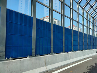 SELANGOR, MALAYSIA - JULY 18, 2020: Noise barriers are installed along the vehicle lane bordering the residence to prevent noise pollution to the surrounding locals.