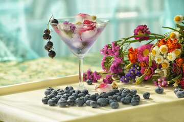 Cooling original drink with ice cubes and flowers 