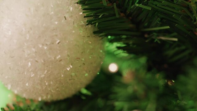 White Christmas ball hanging on the Christmas tree