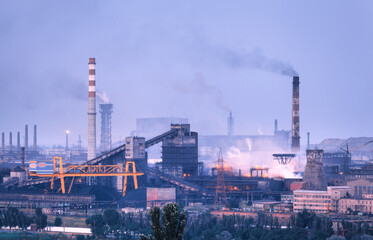 Fototapeta Azovstal in Mariupol, Ukraine before war. Steel plant at night. Steel factory with smokestacks. Steel works, iron works. Heavy industry. Industrial landscape with metallurgical combine, smokes, lights obraz