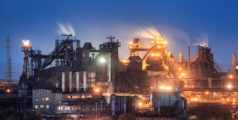 Azovstal in Mariupol, Ukraine before war. Steel plant at night. Steel factory with smokestacks. Steel works, iron works. Heavy industry. Industrial landscape with metallurgical combine, smokes, lights - obrazy, fototapety, plakaty