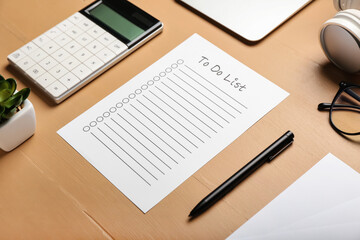 Blank to do list, pen and calculator on color table