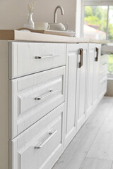 White kitchen drawers in modern room