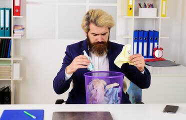 Bearded businessman with trash can. Office worker with wastebasket. CEO. Business. Paper recycling.
