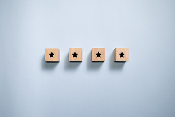 Top view wooden blocks with star rating graphic. Concept for rating and customer satisfaction.